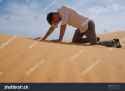 stock-photo-man-walking-alone-in-the-sunny-desert-he-is-lost-and-out-of-breath-no-water-and-energy-concept-765317947