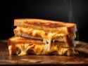 ai-generated-cheese-sandwich-on-a-wooden-board-shallow-dof-free-photo