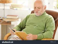 stock-photo-old-man-sitting-at-home-reading-book-in-armchair-67481533