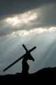 jesus-carrying-the-cross-with-dark-and-moody-sky