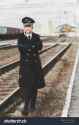 stock-photo-european-or-american-train-conductor-is-on-his-duty-on-a-platform-and-other-trains-railway-steam-2060772623