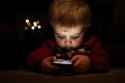 a-child-playing-with-a-cell-phone-photo