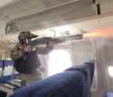 SWAT with a SPAS 12 fires in a airplane
