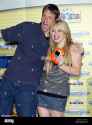 tony-hawk-and-hilary-duff-pose-for-pictures-after-introducing-hasbros-videonow-color-portable-video-player-at-toys-r-us-in-new-york-on-july-15-2004-upi-photolaura-cavanaugh-TYGN62[1]